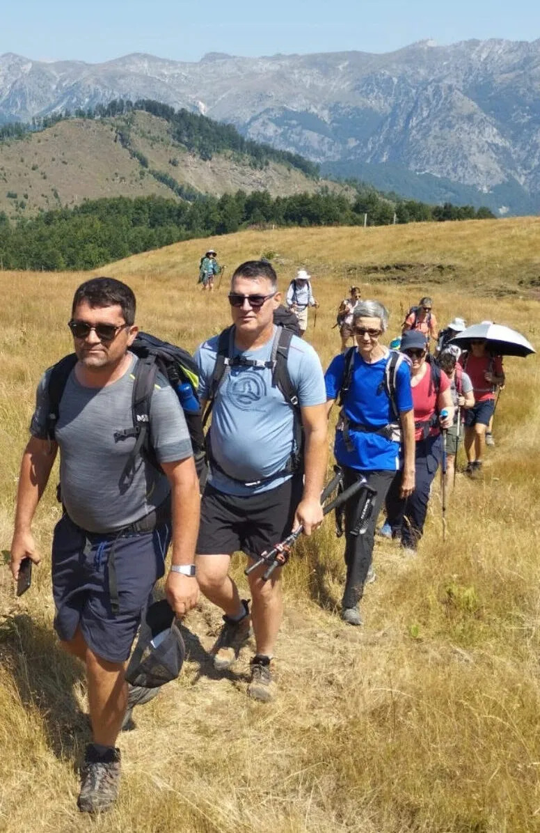 Alfred Cekja leading a hiking group through the Albanian mountains