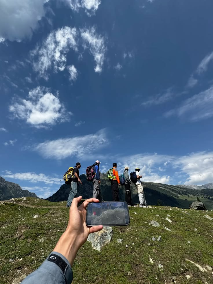 Hikers being filmed on a mountain trail