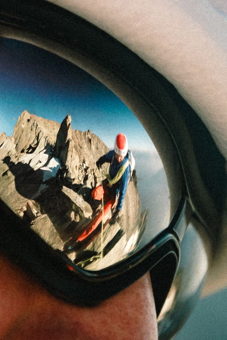 Mountaineer reflected in climbing goggles