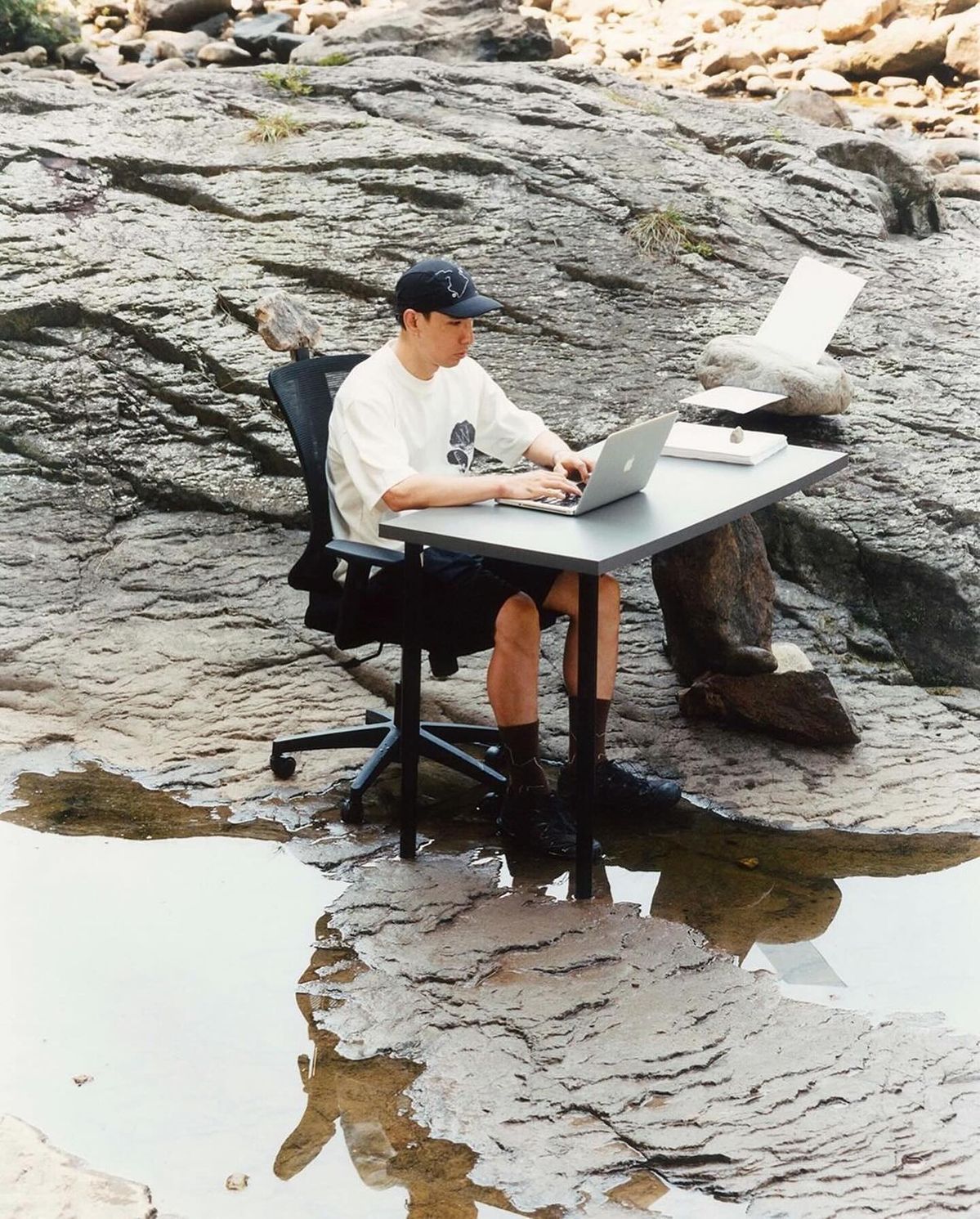 Creator working on a laptop outdoors