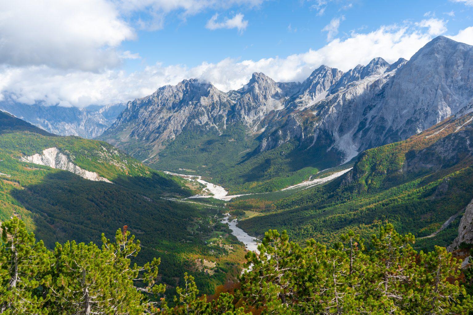 Forested valley and dramatic peaks of the Albanian Alps