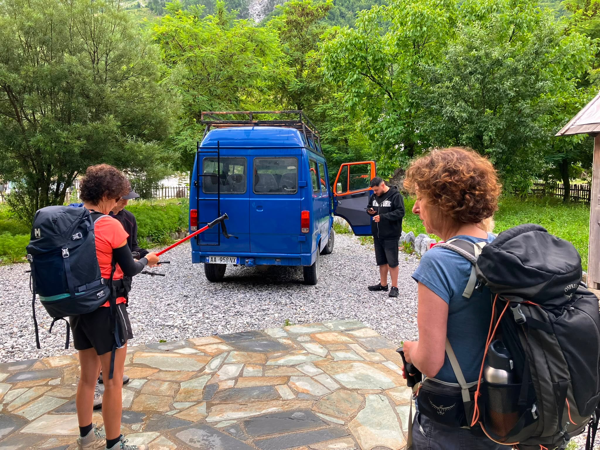 Hikers preparing beside their transfer for a guided journey in Albania