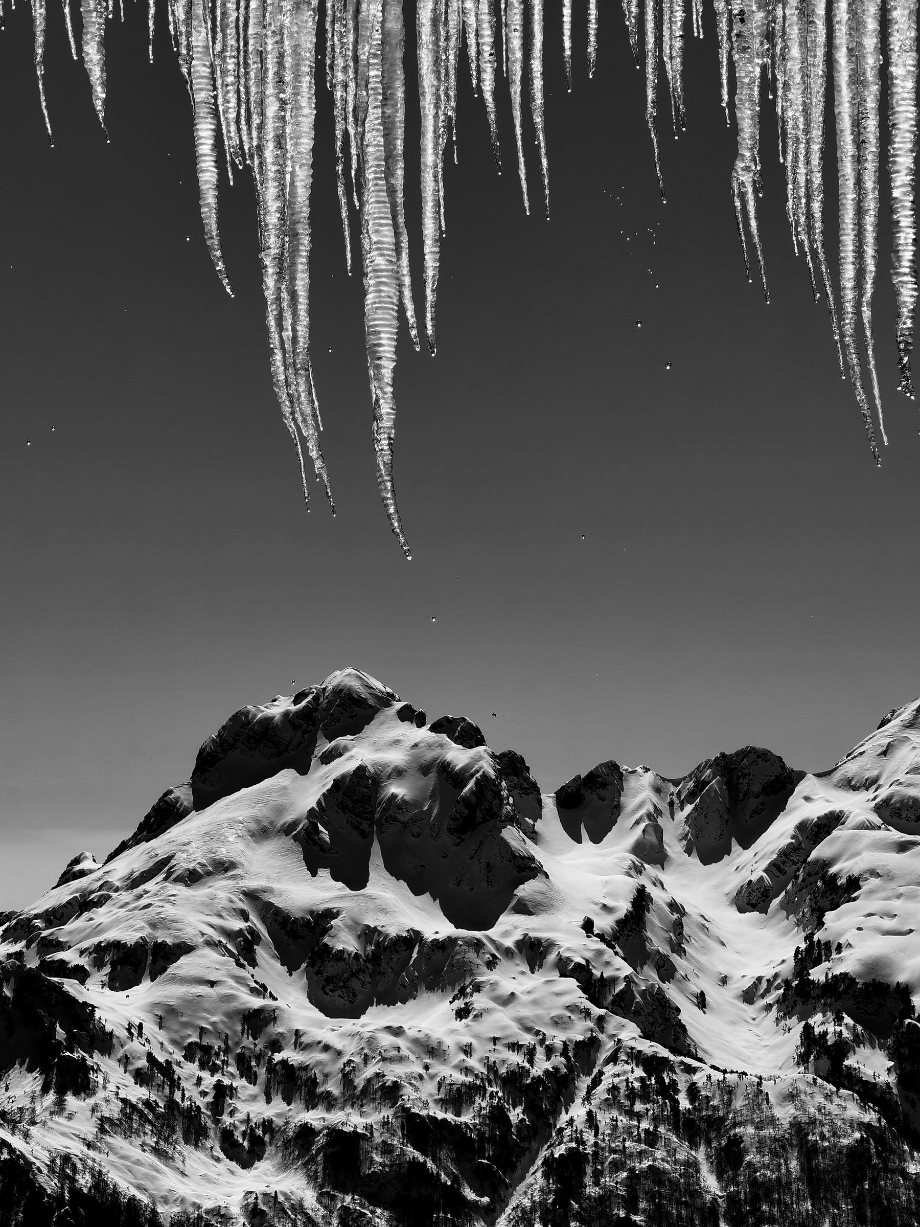 Icicles framing the snow-covered peaks above Theth