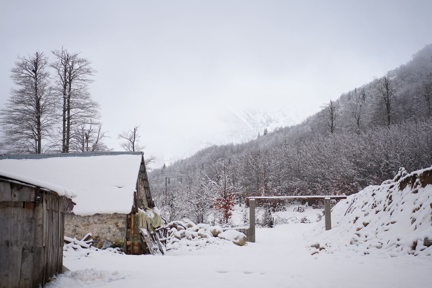 Snow-covered guesthouse and valley in Valbonë, Albania
